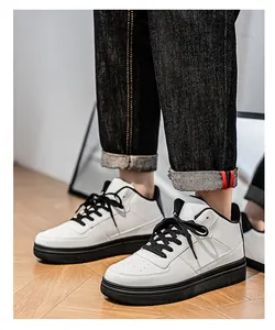 Stylish white low-top sneakers for men featuring black soles and laces on feet