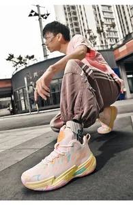 Detailed view of stylish men's color-blocked mid-top basketball shoes on an urban street