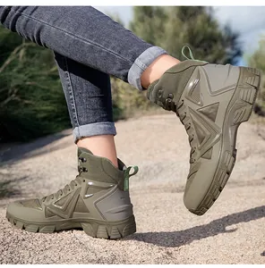 Side view of olive green mid-top tactical hiking boots on a dusty outdoor trail path