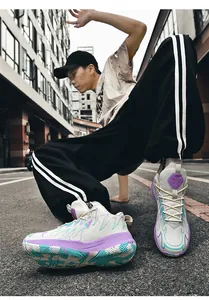 Detailed view of color-block mid-top basketball shoes with thick durable soles on a street.