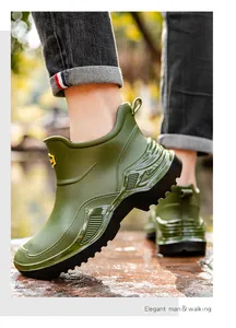 Detailed view of green waterproof short rain boots for men with thick anti-slip soles.