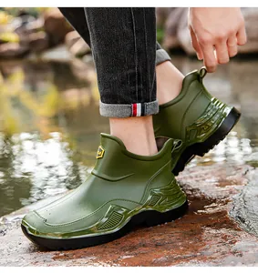 Detail view of olive green short rain boots showing waterproof material and durable thick sole.