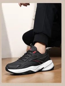Close-up of black leather platform sneakers with red accents and white sole