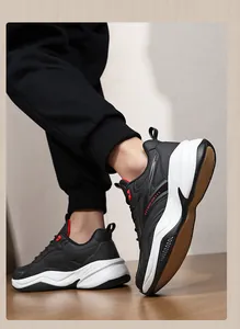 Detail view of men's leather chunky running sneakers with thick sole and black white design.