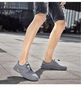 Man draagt grijze mesh wandelschoenen op straat, ademend en lichtgewicht ontwerp.