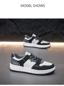 Gedetailleerd overzicht van lage modieuze sneakers met zwart-wit lederen patchworkontwerp.