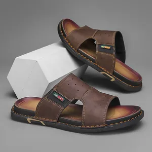 Gros plan de sandales marron pour hommes avec coutures décoratives et étiquette.
