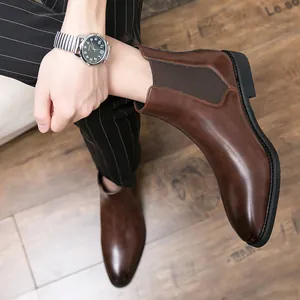 Elegant brown men's Chelsea boots with a sleek pointed toe and elastic side panels