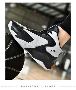 High-top contrast color basketball shoe with leather surface resting on a ball
