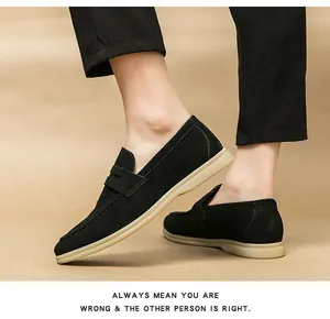 Close-up detail of men's black suede penny loafers on model for business casual style