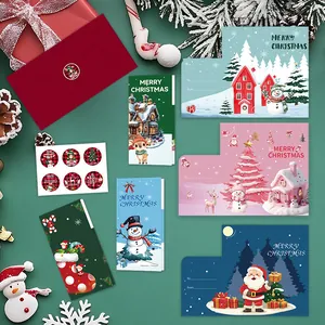 Collection of festive Christmas cards, red envelopes, and stickers on green background.
