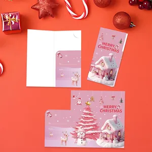Close-up detail of a pink folding Christmas card with snowman and tree illustrations
