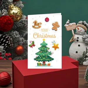 Vue détaillée d'une jolie carte de Noël avec sapin festif et texte sur boîte rouge