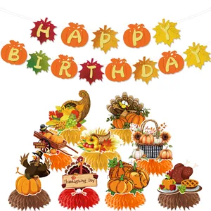 Thanksgiving party decorations set featuring Happy Birthday banner and honeycomb centerpieces