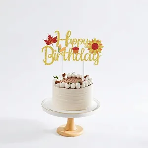 Detailed view of large glittery 'Happy Birthday' Thanksgiving cake topper with fall elements