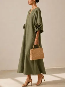 Full shot of elegant olive green cotton linen maxi dress with 3D flower sleeve detail