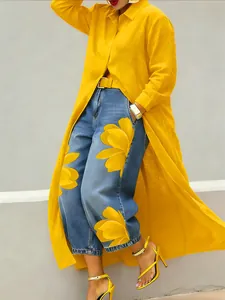 Detailed view of a long yellow button-down shirt dress with a stylish lapel collar.