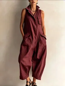 Detailed view of the sleeveless burgundy jumpsuit with utility pockets and wide legs