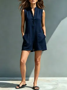 Detailed view of navy cotton-linen sleeveless romper with stand collar and buttons.
