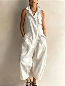 Detail view of white sleeveless utility jumpsuit featuring multiple pockets and stand collar