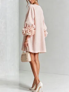 Detail of 3D floral lantern sleeves on a pink French style linen holiday mini dress.