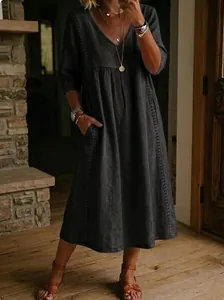 Detail view of the elegant charcoal cotton linen dress with V-neck and lace trim