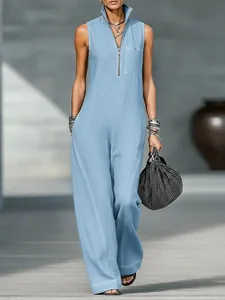 Detail view of light blue sleeveless wide-leg jumpsuit with stand collar and zipper