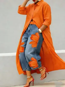 Elegant long orange button-up shirt dress styled with stylish floral denim jeans
