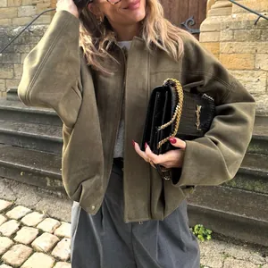 Close-up view of a premium olive green suede aviator jacket with stylish batwing sleeves.