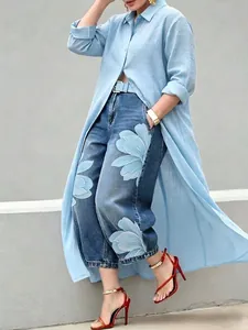 Detail view of a light blue long button-down shirt dress with an elegant lapel