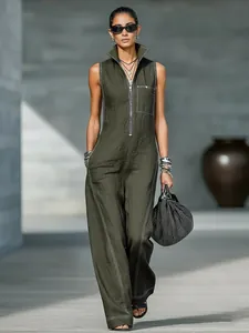 Dark green sleeveless jumpsuit with stand collar and white contrast stitching