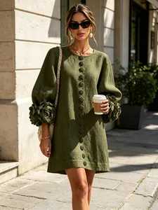 Close-up detail of a green cotton linen dress featuring 3D floral lantern sleeves