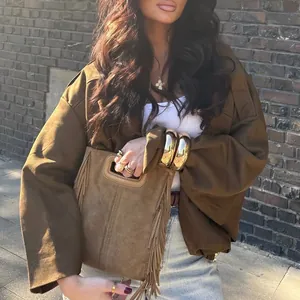 Close-up of brown suede aviator jacket with batwing sleeves and zipper