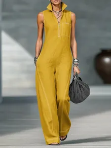 Fashionable yellow sleeveless cotton linen jumpsuit with stand collar and white stitching detail.