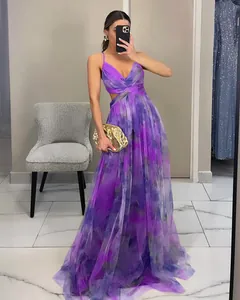 Close-up detail of a vibrant purple floral mesh camisole maxi dress with waist cutout