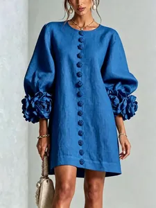 Detailed view of a French blue cotton linen dress featuring 3D flower lantern sleeves