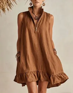 Detailed view of camel sleeveless linen dress featuring V-neck zipper and ruffled hemline.