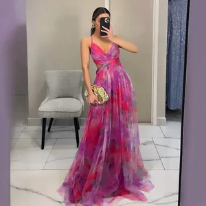 Elegant pink floral print tulle maxi dress with spaghetti straps, perfect for beach vacations.