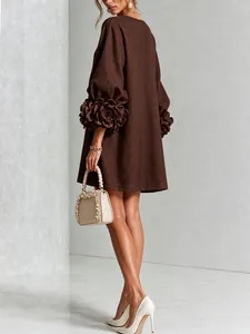 Detailed back view of a brown French linen dress featuring elegant 3D flower lantern sleeves