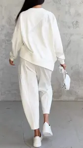 Back view of a white irregular long-sleeve sweatshirt and matching casual pants set.