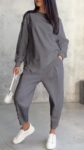 Modern grey women's two-piece loungewear set featuring an irregular hem sweatshirt and pants