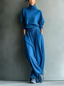 Full view of women's blue high-neck sweatshirt and wide-leg drawstring pants set