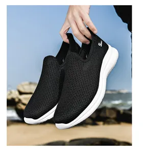 Detailed view of breathable black fly-knit mesh sneakers with white wavy sole for men