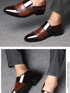 Detail view of two-tone brown men's slip-on business dress shoes with pointed toe design.