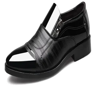 Close-up of black leather business shoe with side zipper detail and textured panels
