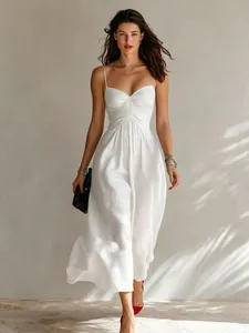 Elegant white strappy maxi dress with ruched bodice details worn by a fashion model