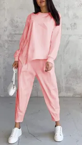 Casual pink round neck sweatshirt and matching pants tracksuit set shown on a model