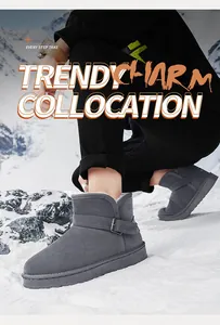 Close-up of warm gray snow boots with buckle detail in a snowy winter setting