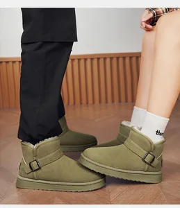 Close-up detail of green fleece-lined winter snow boots with buckle strap detail