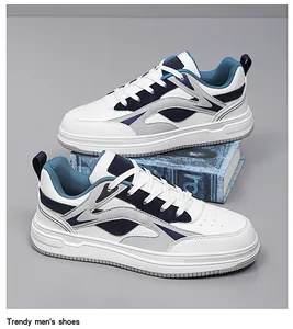 Side view of white and blue chunky low-top men's fashion sneakers on grey background